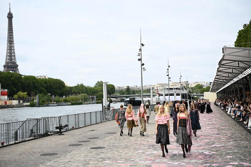 Chanel’s models paraded alongside the River Seine with the Eiffel Tower in the background. 