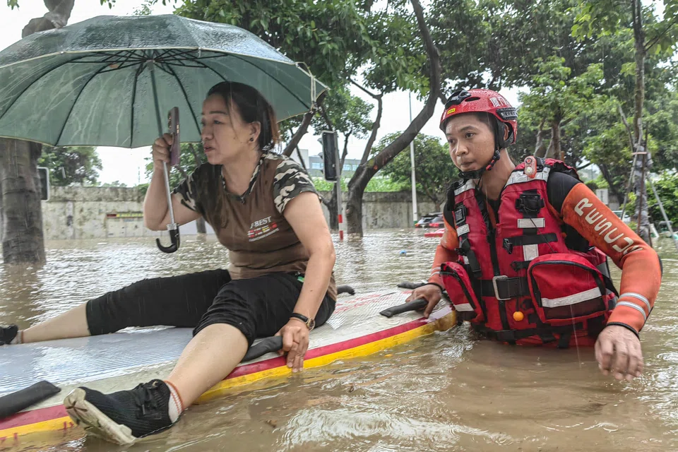 A woman being evacuated from a flooded area following heavy rains caused by Typhoon Haikui in Xiamen, in China's southern Fujian province. Economic losses have reached 5.05 billion yuan (S$942.7 million). 