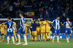 Barcelona's players celebrate winning their 27th Spanish league championship after the Spanish league football match between RCD Espanyol and FC Barcelona at the RCDE Stadium in Cornella de Llobregat on May 14, 2023. 