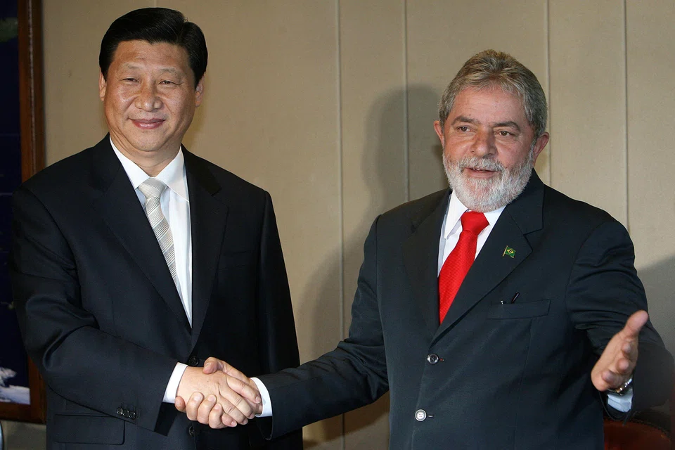 In a file photo taken on Feb 19, 2009, Chinese Vice-President Xi Jinping (left) shakes hands with Brazilian President Luiz Inacio Lula da Silva, during a meeting in Brasilia. Lula will meet President Xi Jinping in Beijing on Friday.