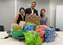 Simon Cooper (centre) and StanChart volunteers collecting gifts for children under the Grant-A-Wish project.