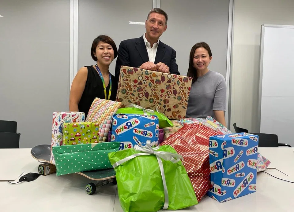 Simon Cooper (centre) and StanChart volunteers collecting gifts for children under the Grant-A-Wish project.