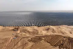 Vehicles preparing land for new solar panels next to a field of solar panels being built at the Ningxia Tengger Desert New-Energy Base in China’s northern Ningxia region last year.  
