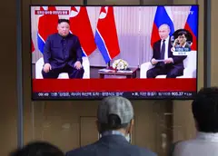 People watch a news segment detailing North Korean leader Kim Jong-un's visit to Russia at a train station in Seoul, South Korea, Sept 12, 2023. 