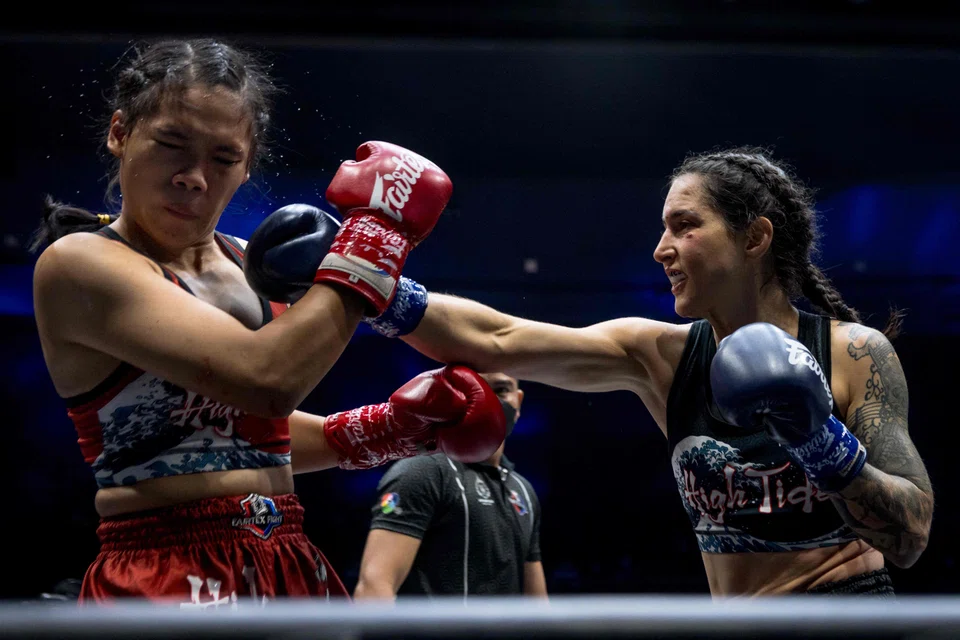 Muay Thai boxer Natalie Morgan (right) from the US striking her Thai opponent Petchnapha Sor Kanitsorn. Thai officials are angry at plans by Cambodia to refer to the event – which they regard as their national sport – on the official programme as Kun Khmer instead of Muay Thai.