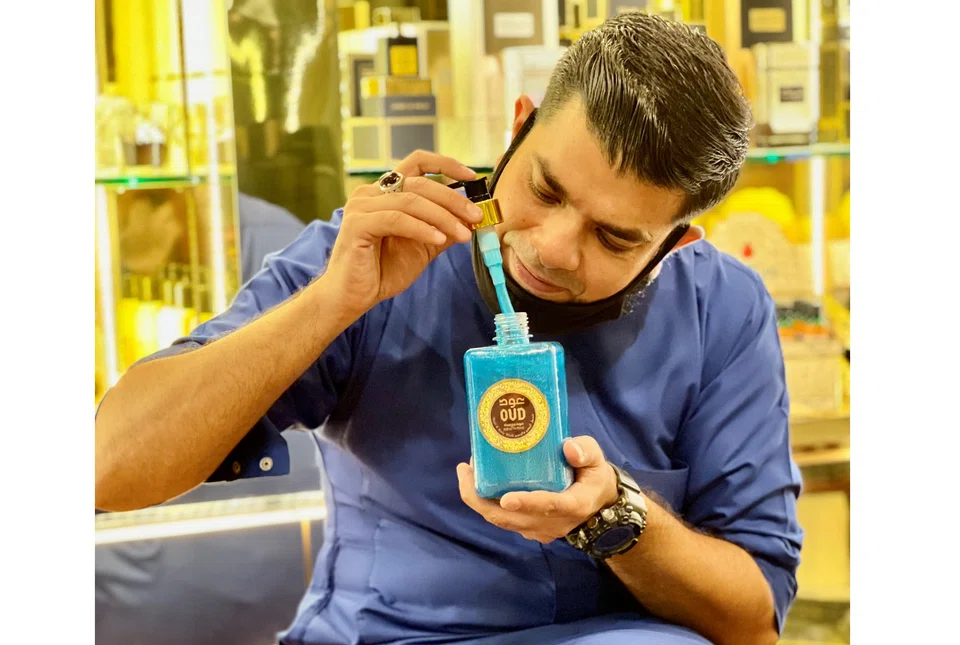 Zee Shan Impex owner Muhammad Fahad Azeem, 37, with his product from OUD Luxury Collection. 