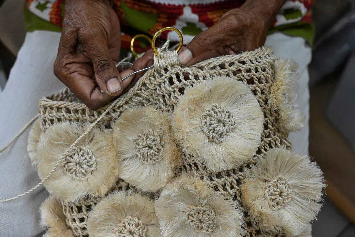 The boutique workshop in Port Moresby hosts a group of women who specialise in intricately lacing plant fibres together to make roomy pouches known as bilums, a symbol of indigenous pride.