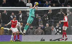 Goalkeeper Aaron Ramsdale of Arsenal makes a save during the English Premier League football match between Tottenham Hotspur and Arsenal in London, Britain, Jan 15, 2023.  