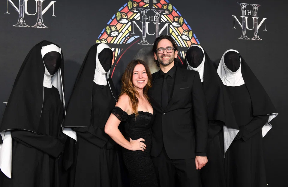 US director Michael Chaves and his wife, casting director Dina Buglione, arrive for a special screening of "The Nun II" at the Regal LA Live in Los Angeles, California, on Aug 30, 2023. 