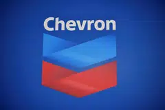 Despite the nearly 40 per cent fall in annual profit, Chevron announces it would increase its dividend by 8 per cent in a sign of confidence. 
