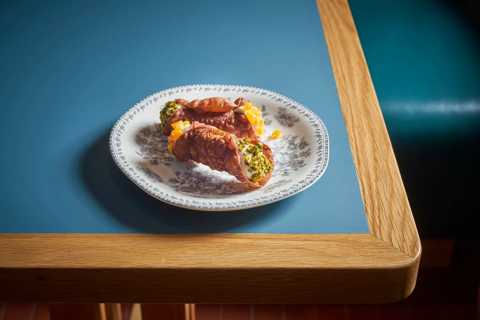 Sweeten the meal with cannoli - fried cigars filled with gelato.