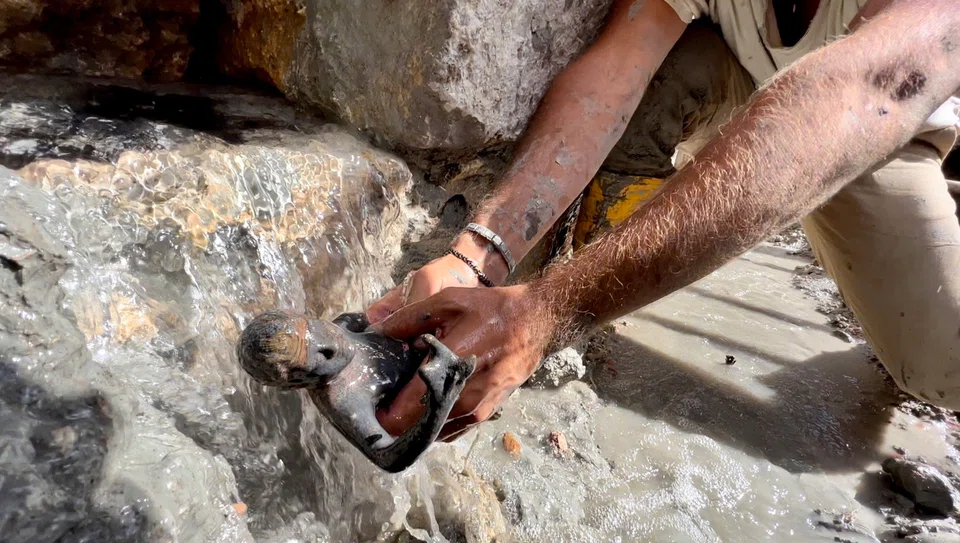 A statuette of a young man emerging from the mud during the discovery of a votive deposit in the excavations of San Casciano dei Bagni, Tuscany, Italy.