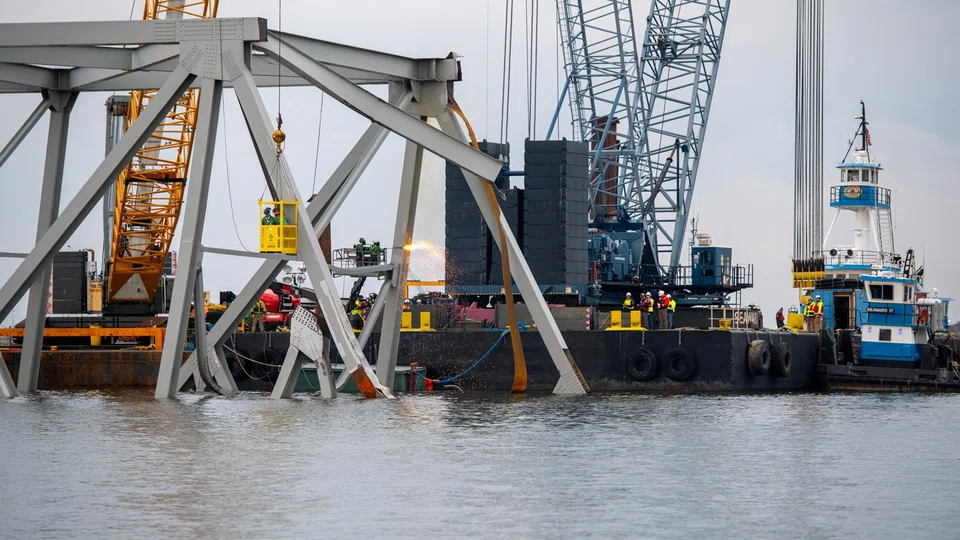 Demolition crews cut the top portion of the north side of the collapsed Francis Scott Key bridge into smaller sections for safe removal by crane in the Patapsco River, in Baltimore, Maryland, March 30, 2024. 