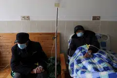 Tang Shunping, 80, receives IV drip treatment at a clinic in a village of Lezhi county after strict measures to curb Covid-19 were removed nationwide, in Ziyang, Sichuan province, China, Dec 29, 2022. 