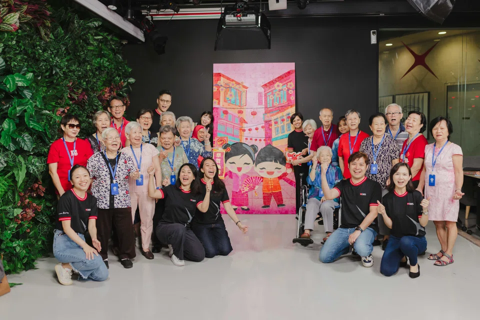 Seniors from Lions Befrienders and DBS volunteers upcycled 4,300 kg of red packets into a 2.5-metre-tall artwork replicating the bank’s 2024 hongbao design.