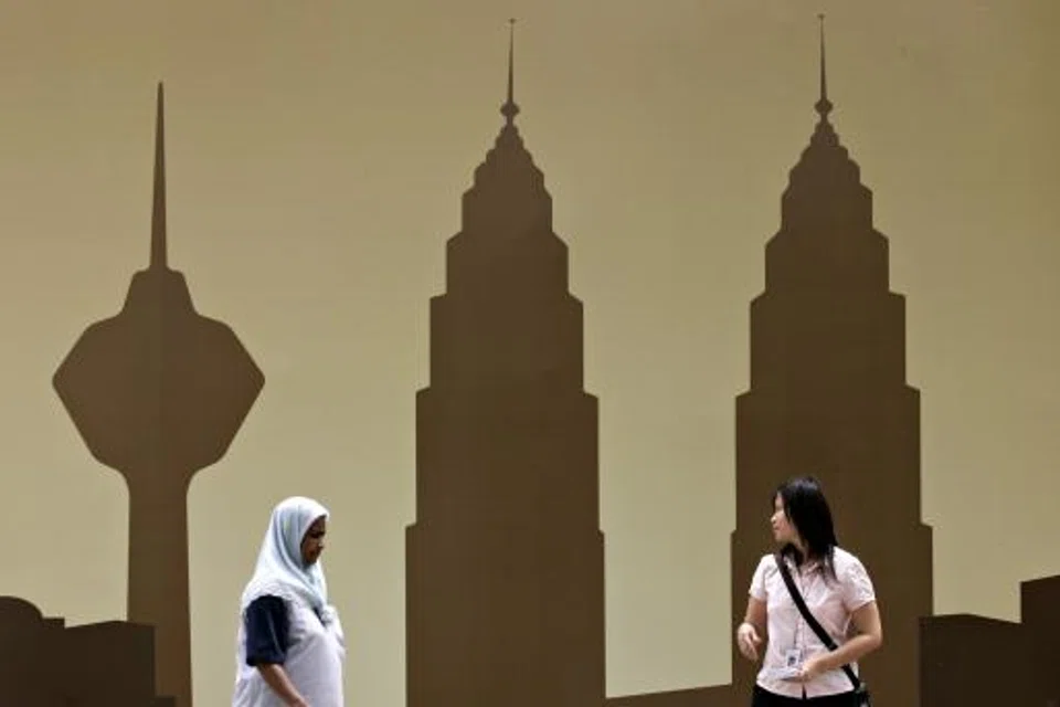 Kuala Lumpur's iconic Petronas twin towers depicted on a billboard in the capital of Malaysia. On the country's bourse on Friday (Nov 11), 3.436 billion lots worth RM2.428 billion changed hands. 