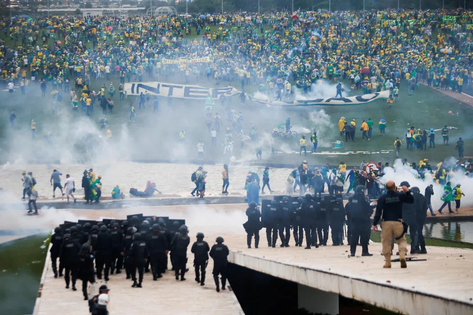 Supporters of Brazil's former President Jair Bolsonaro demonstrate against President Luiz Inacio Lula da Silva while security forces operate, outside Brazil’s National Congress in Brasilia, Brazil, Jan 8, 2023.