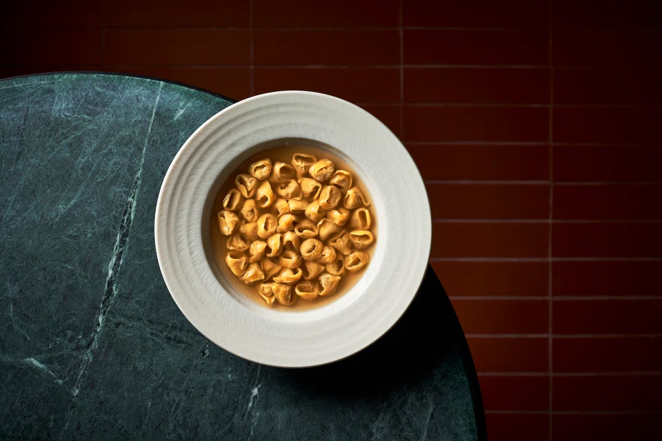 Tiny tortellini in chicken broth.