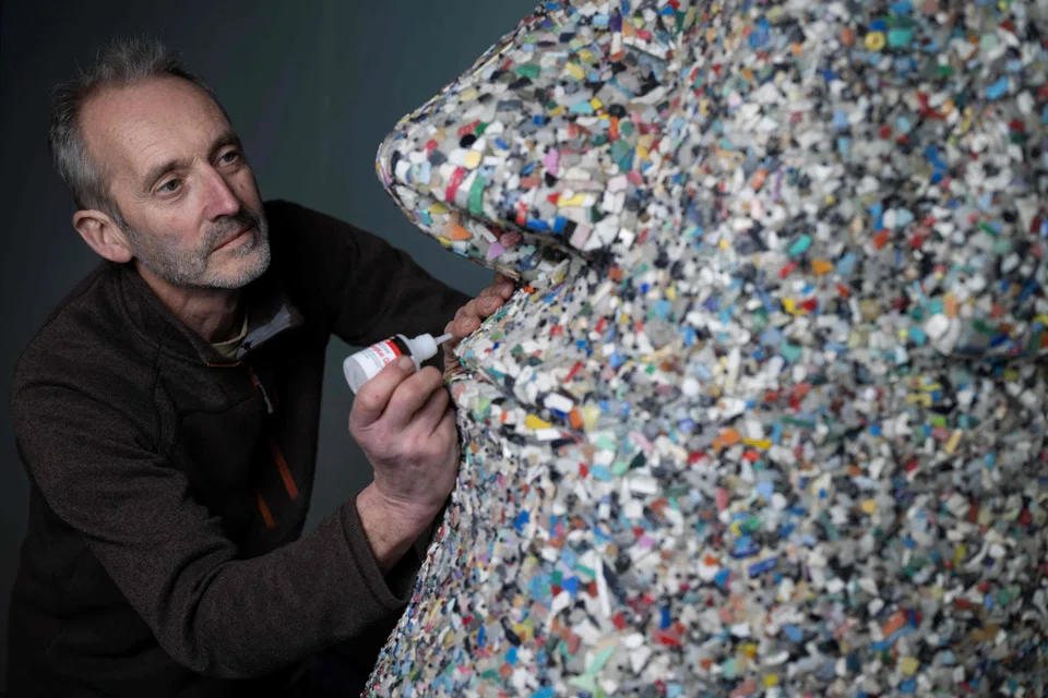 Artist and environmental activist Rob Arnold working on the sculpture called "A Lesson of history"; the work is on display at the National Maritime Museum Cornwall in the coastal town of Falmouth.