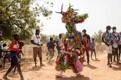 Fairy masquerade dances to drums along the streets during the kankurang Festival in Janjanbureh. The Kankurang – a combination of the Mandinka words “kango” and “kurango” which literally translate as “voice” and “enforce” – has been listed by Unesco as Intangible Cultural Heritage since 2005.