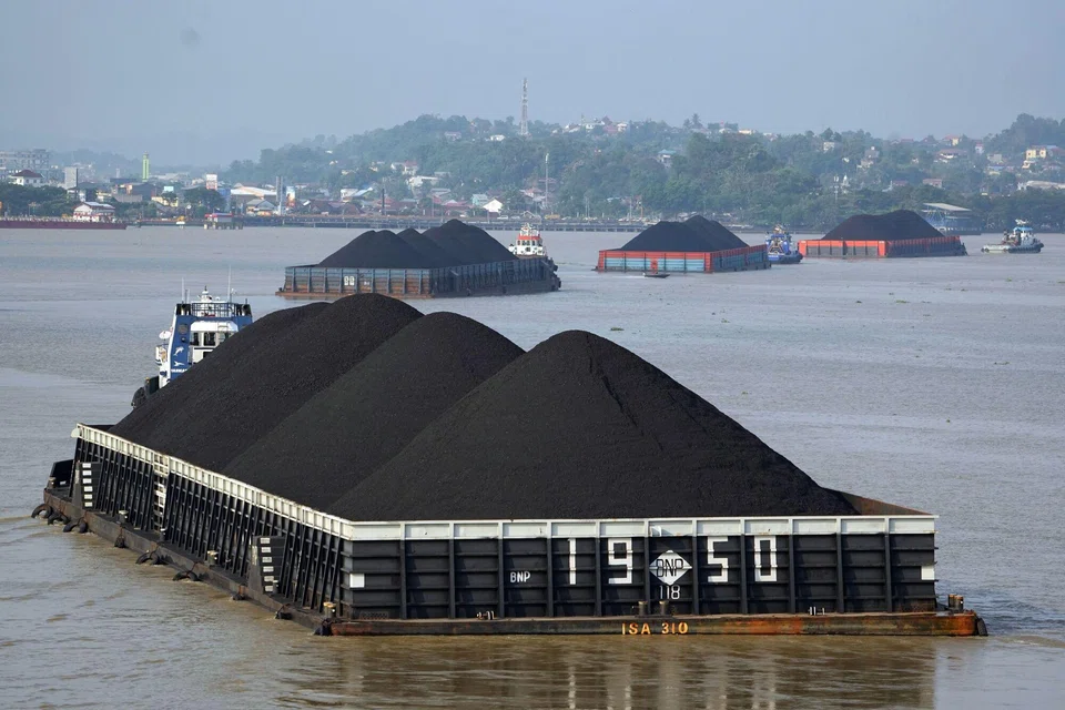 Barges transporting coal on the Mahakam River in  Indonesia. The world urgently needs to wean off fossil fuels, but this has been difficult with soaring inflation.
