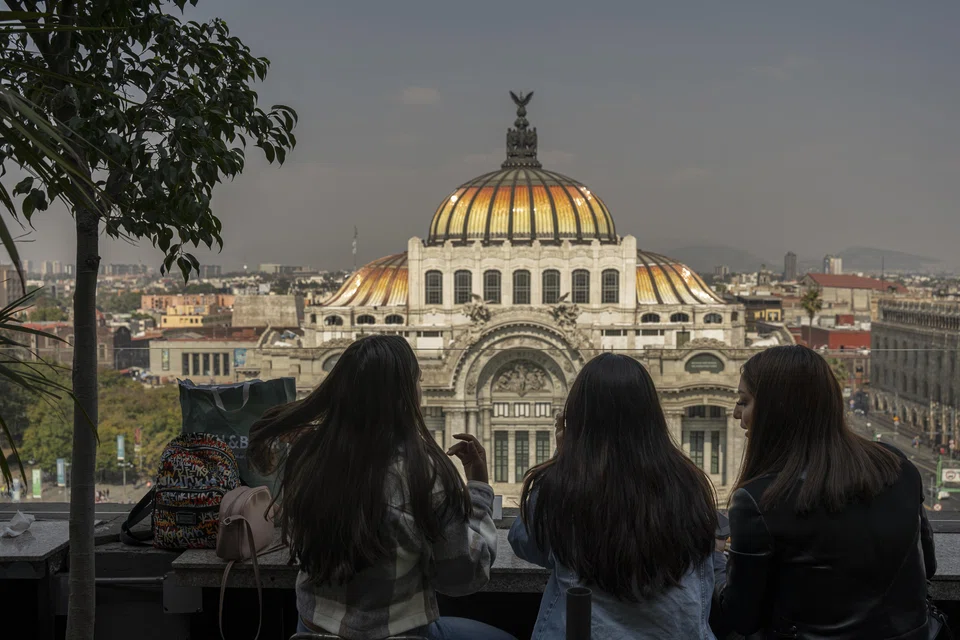 Tourists looking at the Palace of Fine Arts in Mexico City. American and Europeans are using Airbnb to find long-term rentals in Mexico’s capital, pushing houses costs higher. 