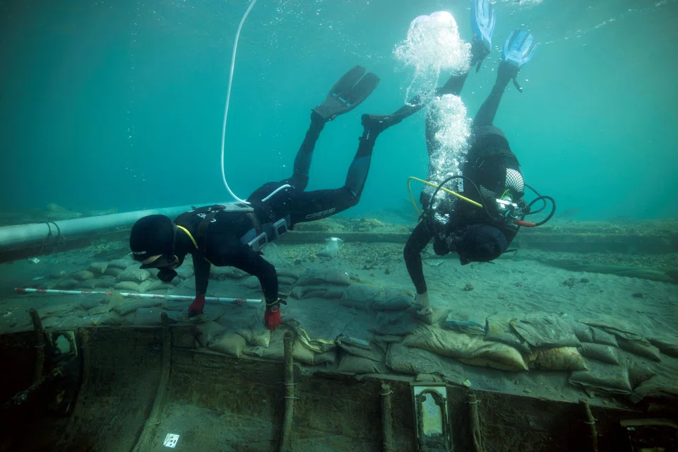 Divers from Valencia University map and assess the state of a 2,500-year-old Phoenician vessel that is submerged 60 metres from the beach of Mazarron, Spain.