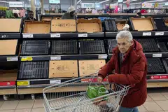 A customer walks past empty shelves at a Sainsbury's supermarket in London. Ministers in the UK have responded to the dearth of fresh vegetables by summoning retailers for a reprimand. 