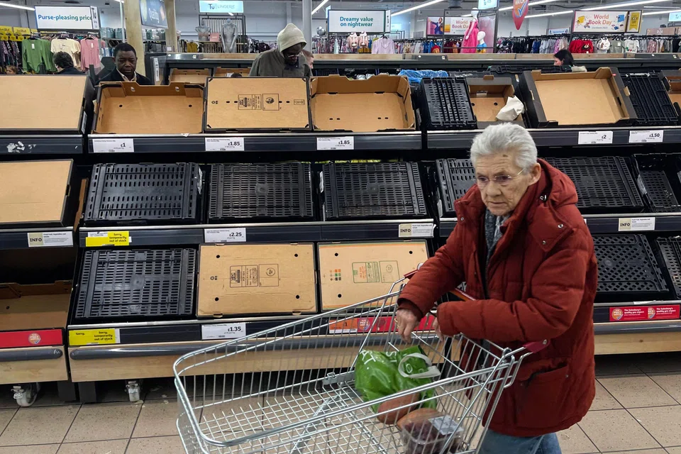 A customer walks past empty shelves at a Sainsbury's supermarket in London. Ministers in the UK have responded to the dearth of fresh vegetables by summoning retailers for a reprimand. 