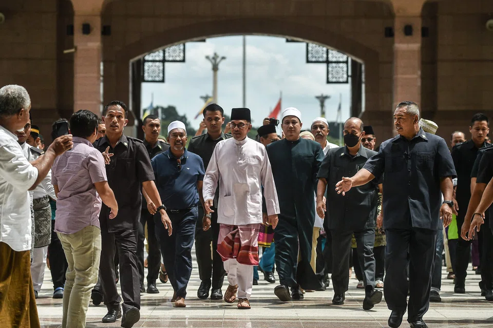 Malaysia's Prime Minister Anwar Ibrahim (in white) leaves a mosque in Putrajaya after Friday prayers last week.