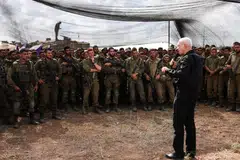 Israel's defence minister Yoav Gallant meets soldiers in a field near Israel's border with the Gaza Strip, in southern Israel, Oct 19, 2023.