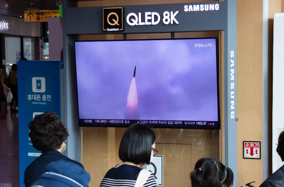 Commuters in Seoul watch the news about a North Korea ballistic missile launch on Sept 30, 2022. 