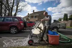 Environmental activist and artist Rob Arnold setting up the machine he built to help clean up the beach in England’s south-western Cornwall region.