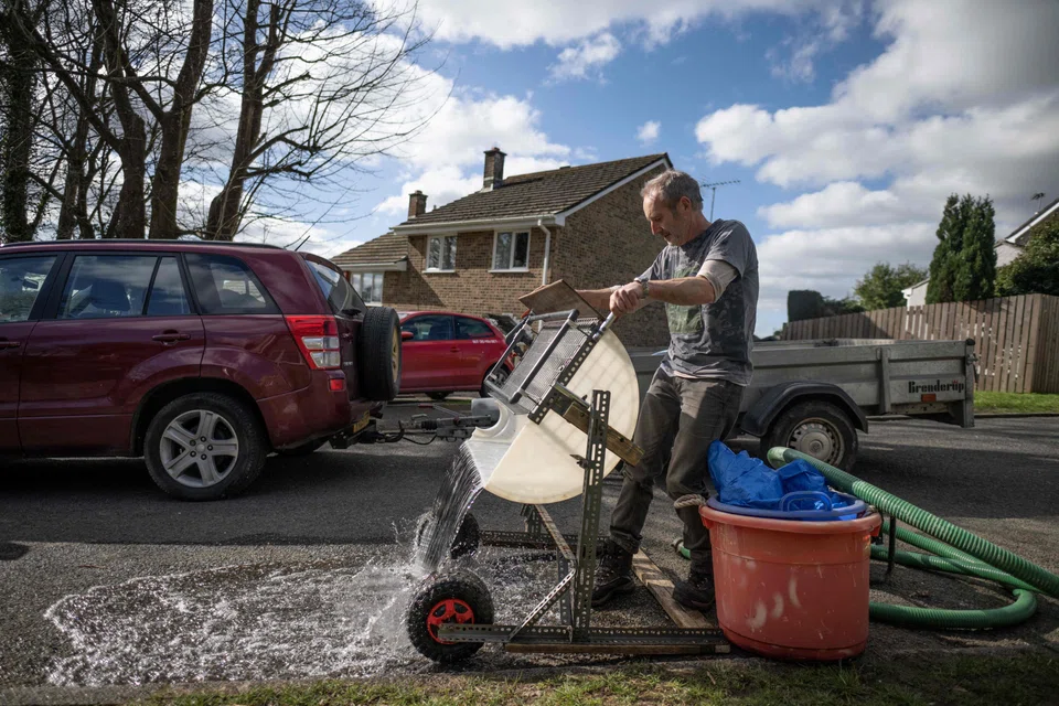 Environmental activist and artist Rob Arnold setting up the machine he built to help clean up the beach in England’s south-western Cornwall region.