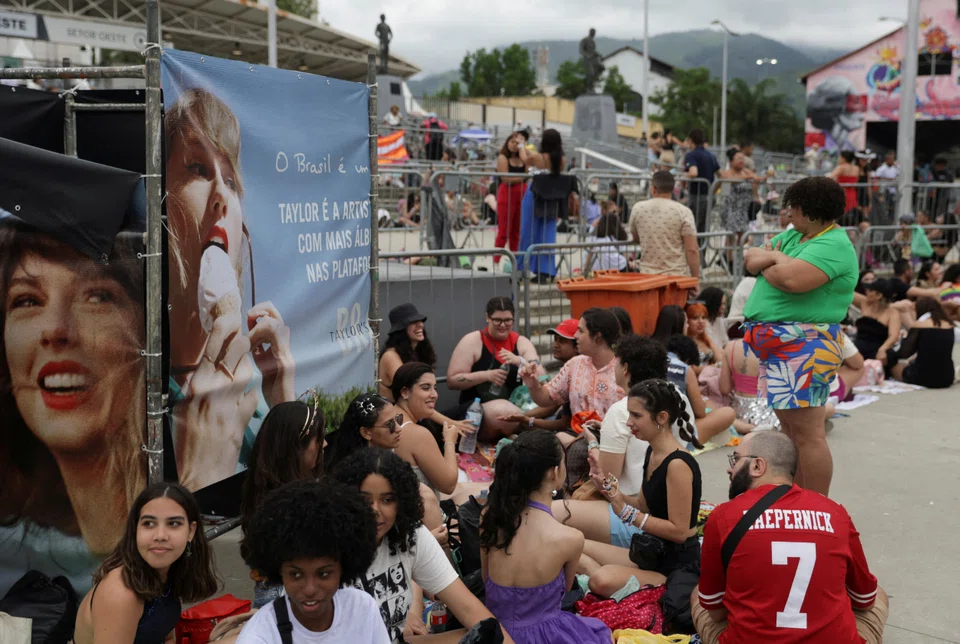 Fans wait in line outside Nilton Santos stadium for the Taylor Swift concert, following the death of a fan due to the heat during the first day concert.