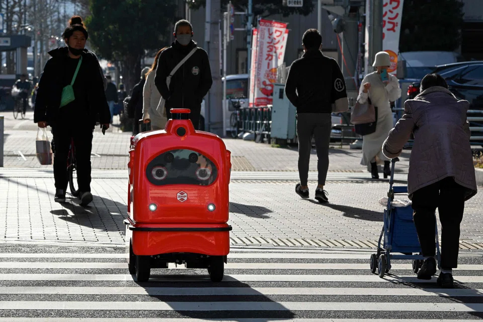 A DeliRo delivery robot moving along on a street outside Tokyo, part of an experiment businesses hope will tackle labour shortages and rural isolation. 