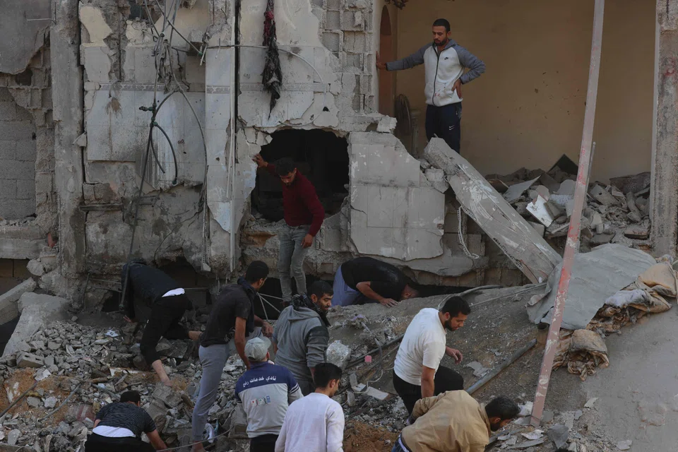 Palestinians inspect the destruction following an Israeli strike in Rafah in the southern Gaza Strip on Dec 1, 2023, as fighting resumed shortly after the expiration of a seven-day truce between Israel and Hamas militants. 