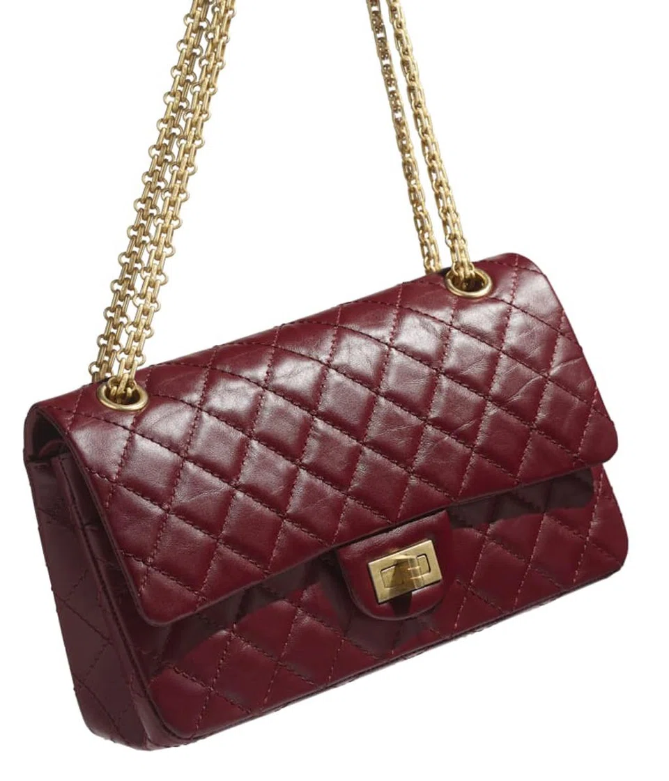 The Chanel "flap" 2.55 handbag in aged calfskin and gold-tone metal.