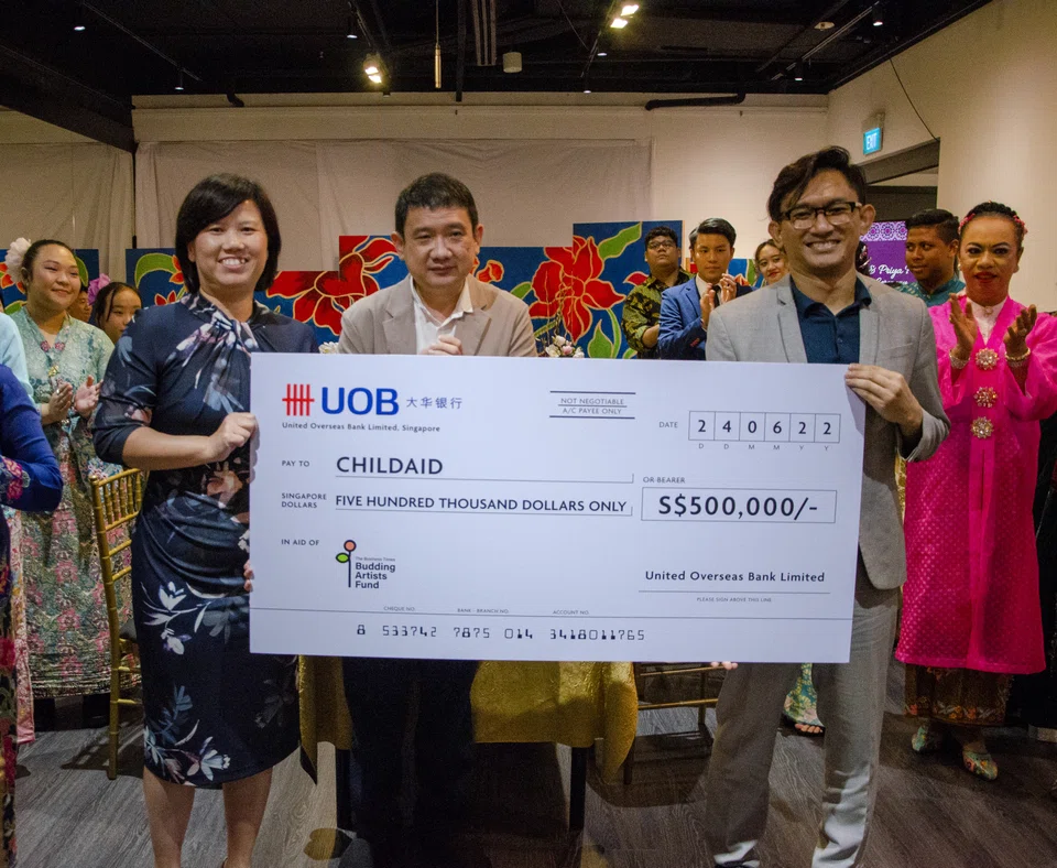 (from left) Ms Janice Leong, Executive Director, Corporate Wealth Management, Commercial Banking, UOB Ltd, presented a cheque donation of $500,000 to ChildAid, represented here by Mr Phan Ming Yen, Chief Operating Officer of The Rice Company Ltd, which manages The Business TImes Budding Artists Fund, and Mr Helmi Yusof, co-chair of the Organising Committee of ChildAid 2022. 