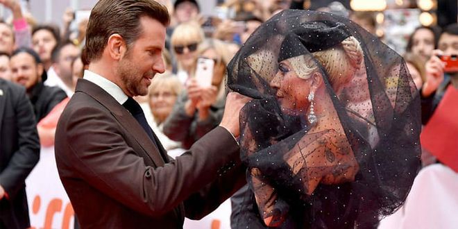 Wearing another jaw-dropping look, Cooper helped Gaga remove her veil for a dramatic reveal at the A the Star Is Born premiere in Toronto.
Photo: Getty