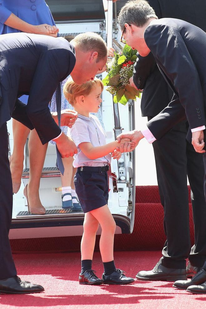 Prince William introduces his son to officials during a royal visit to Germany.

Photo: Getty