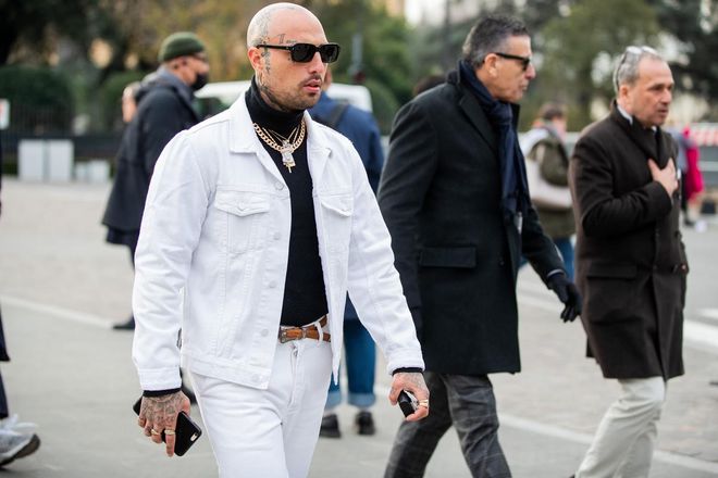FLORENCE, ITALY - JANUARY 07: A guest is seen with tattoos wearing white jacket and pants, black turtleneck during Pitti Uomo 97 at Fortezza Da Basso on January 07, 2020 in Florence, Italy. (Photo by Christian Vierig/Getty Images)