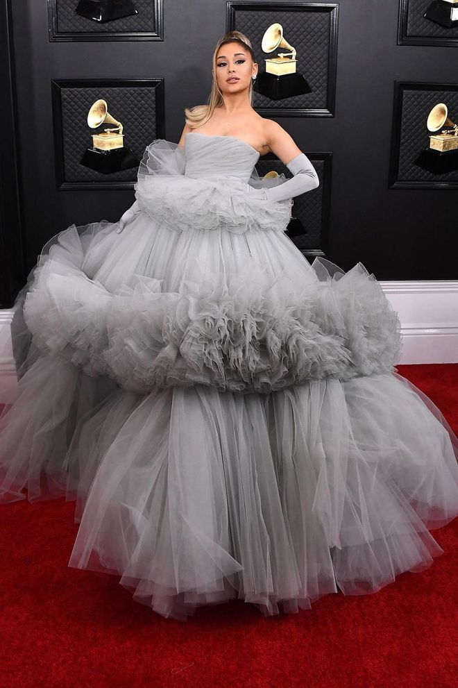 Never one to miss an opportunity to dress up, Ariana Grande made a serious entrance to the Grammys in an enormous grey tulle gown by Giambattista Valli, which she paired with matching opera gloves and her trademark ponytail. Photo: Getty