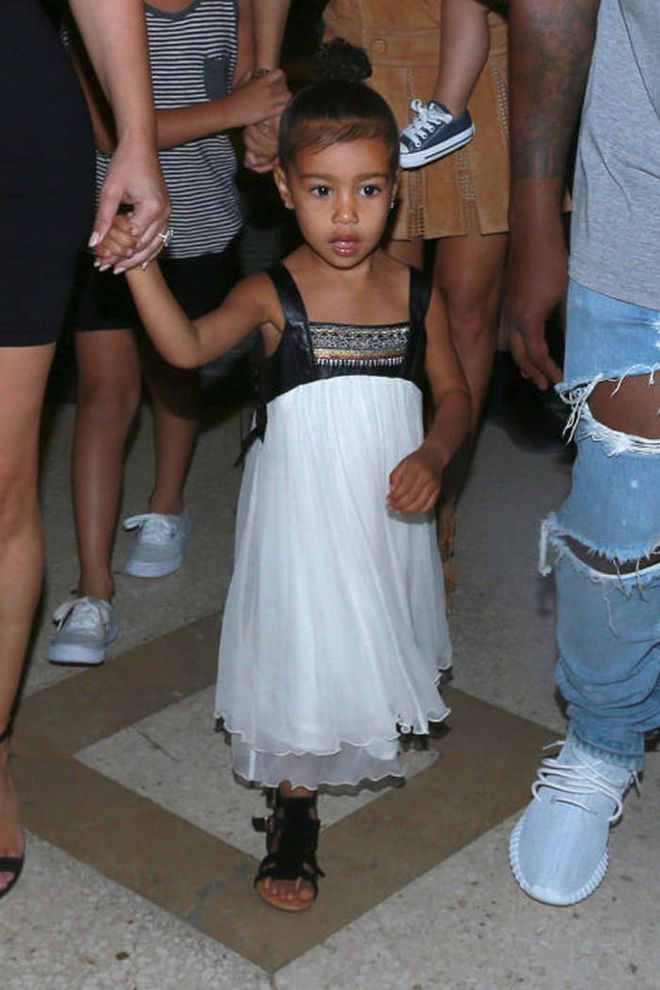 For a night out to dinner in Cuba, the toddler ditched her choker and opted for an empire-style dress, fringe sandals and a top-knot. Photo: Splash