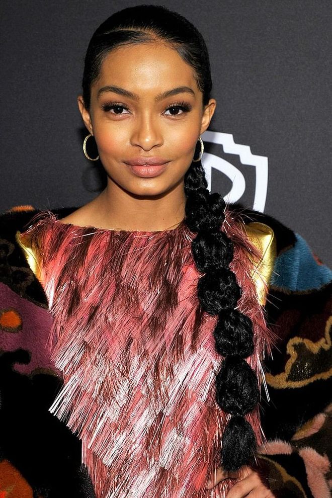 A segmented and textured ponytail is just young and fun enough for the Blackish star. 
