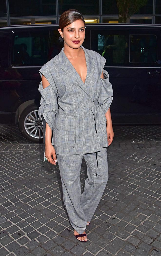 In a slightly oversized grey pant suit with a cut-off sleeve detail. Photo: Getty 