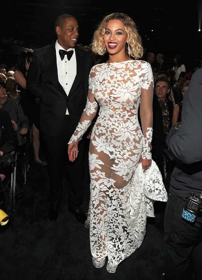 Beyoncé was spotted backstage with hubby Jay Z wearing a *gorgeous* white gown by Michael Costello. The couple performed "Drunk In Love" together during the show. 