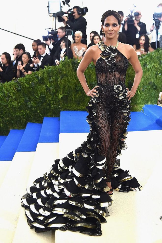 Halle Berry joins in the "sheer black gown" crew with this decadent black and gold scalloped gown that features a sequined see-through body. Photo: Getty 