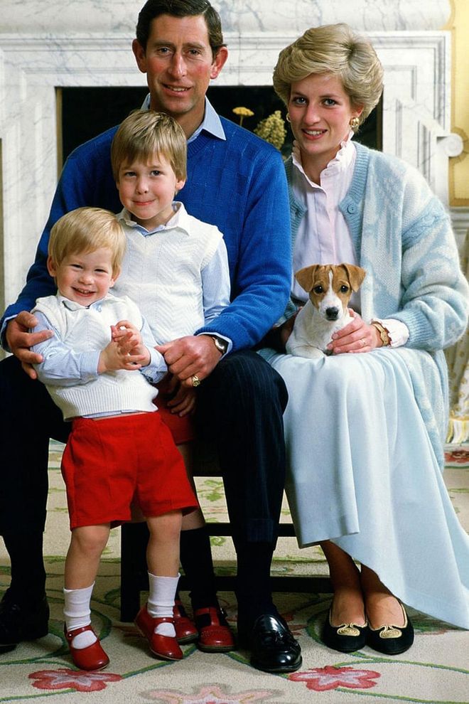 Prince Charles, Princess Diana, Prince William, and Prince Harry pose for a portrait at home in Kensington Palace with their dog. Harry's mischievous smile is too cute—and so are his and William's matching shoes.