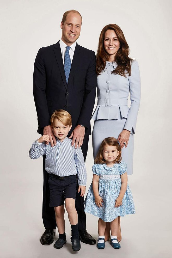 The Duke and Duchess of Cambridge, Prince George, and Princess Charlotte coordinate in matching blue outfits for a photo at Kensington Palace. The family of four used this image for their 2017 Christmas card.